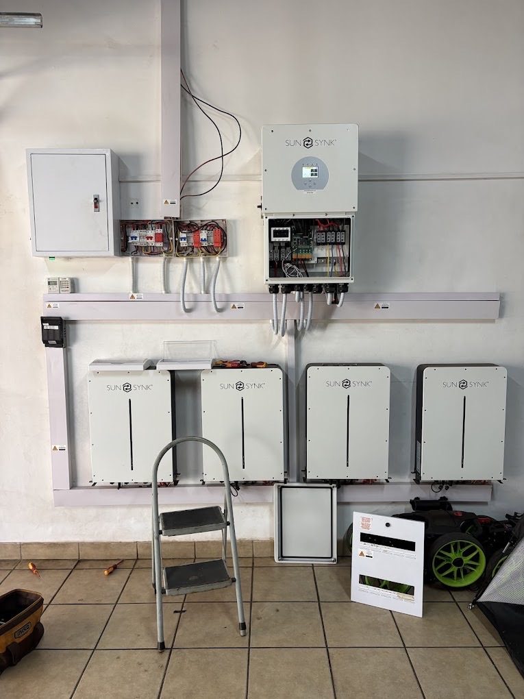 Inverter and a bank of lithium batteries, all neatly boarded.